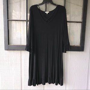 JODIFL dress, solid black, ruffle cuffs and hemline, crossed lace trim on chest